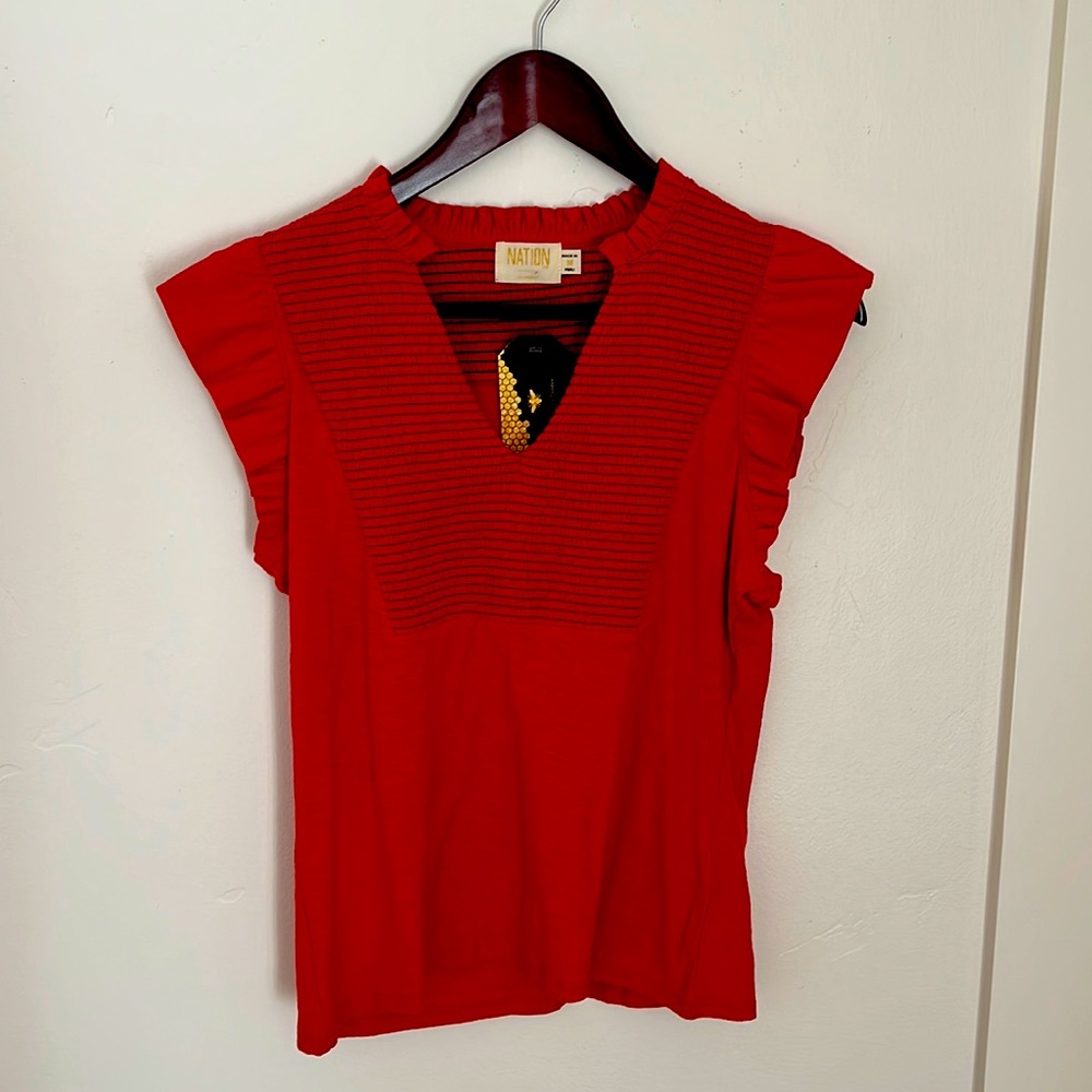 Sleeveless ruffled red top.